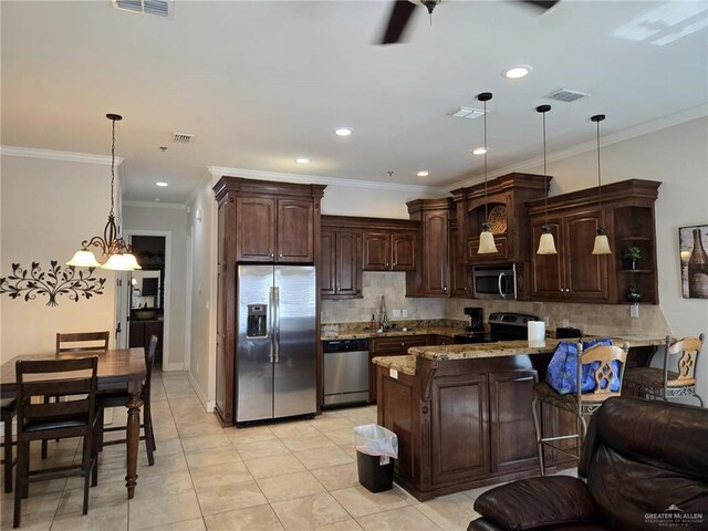 115 E Atol St Unit 3, South Padre Island, TX 78597 - kitchen with appliances with stainless steel finishes, dark brown cabinets, a peninsula, decorative backsplash, and ornamental molding