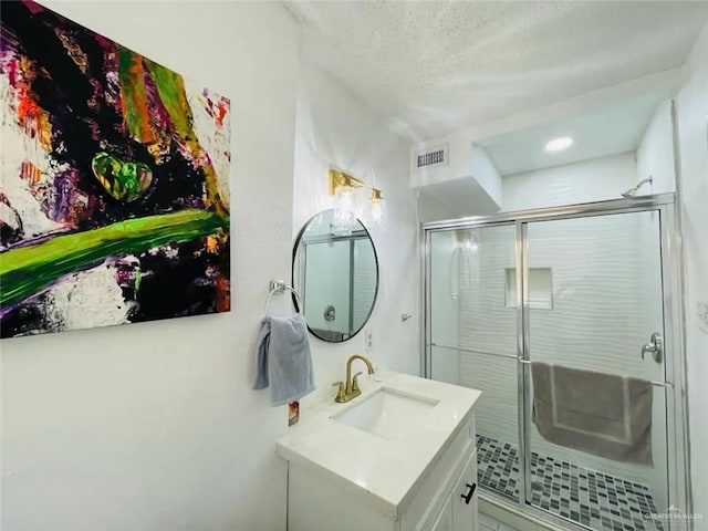 807 Walnut St, Mcallen, TX 78501 - full bath featuring vanity, a shower stall, a textured ceiling, and tile patterned floors