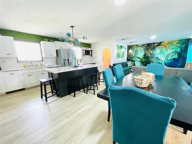 807 Walnut St, Mcallen, TX 78501 - dining area featuring light wood finished floors and a chandelier