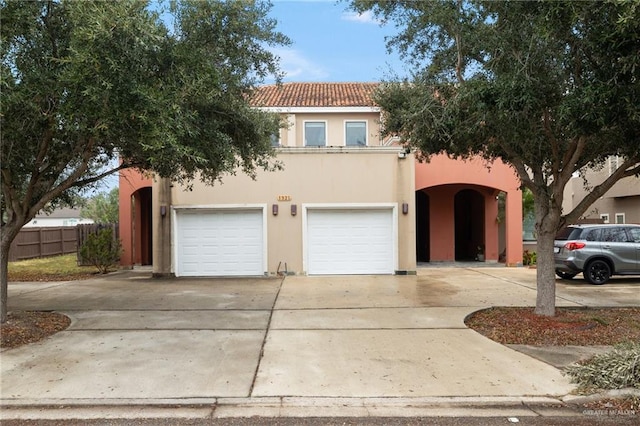 mediterranean / spanish home featuring a garage