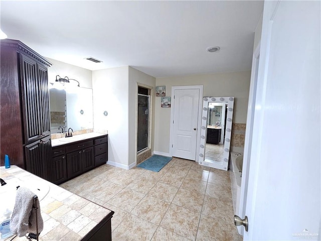 1704 E 30th St, Mission, TX 78574 - bathroom with vanity, tile patterned floors, a tub to relax in, and a shower stall
