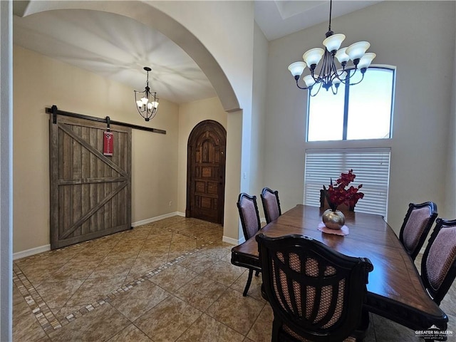 1704 E 30th St, Mission, TX 78574 - tiled dining room with a chandelier, arched walkways, inlaid floor details, and a barn door