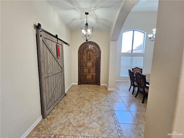1704 E 30th St, Mission, TX 78574 - entrance foyer with a barn door, arched walkways, a chandelier, and light tile patterned floors
