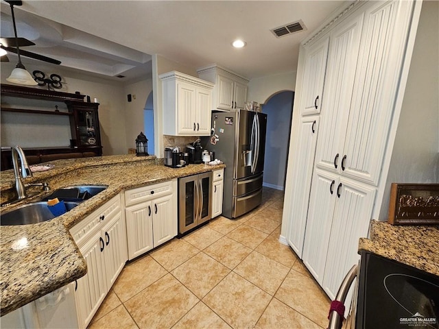 1704 E 30th St, Mission, TX 78574 - kitchen with wine cooler, stainless steel fridge, range with electric stovetop, light stone counters, and light tile patterned floors