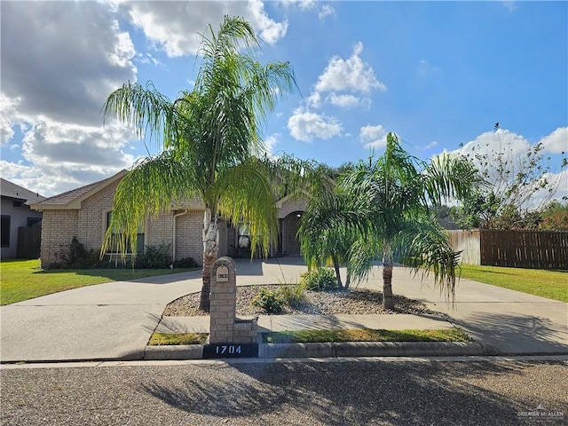 1704 E 30th St, Mission, TX 78574 - obstructed view of property featuring curved driveway and brick siding