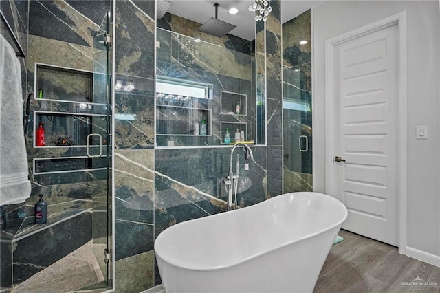 bathroom with hardwood / wood-style floors, shower with separate bathtub, and tile walls