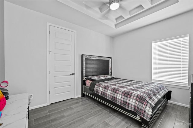 bedroom featuring ceiling fan, hardwood / wood-style floors, and coffered ceiling