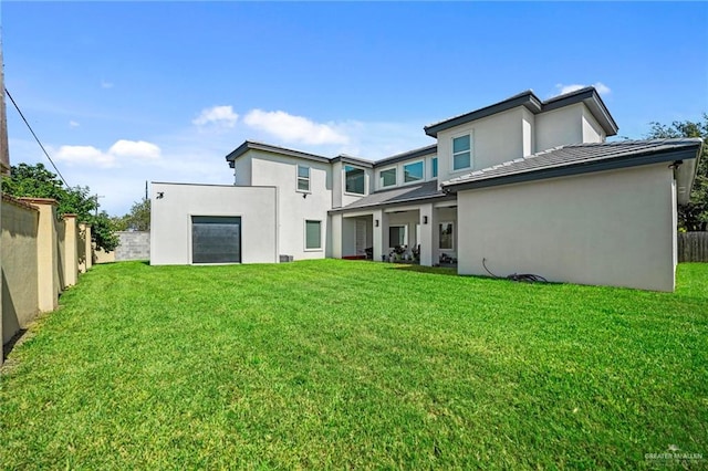 rear view of property featuring a yard