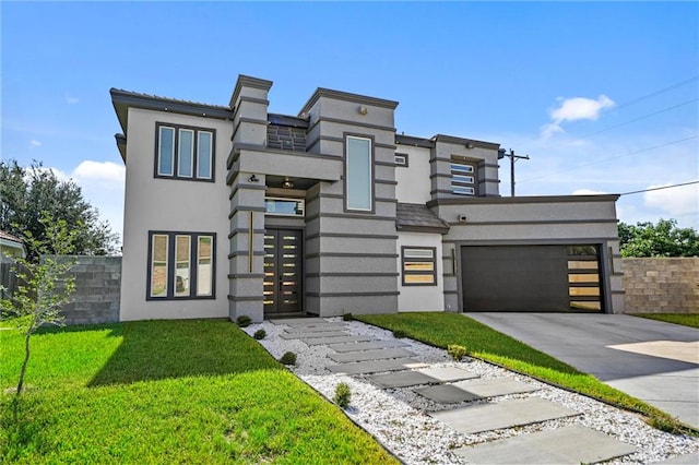 contemporary home with a front yard and a garage