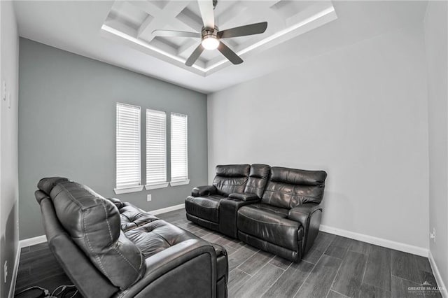 living room with ceiling fan, dark hardwood / wood-style flooring, a tray ceiling, and coffered ceiling