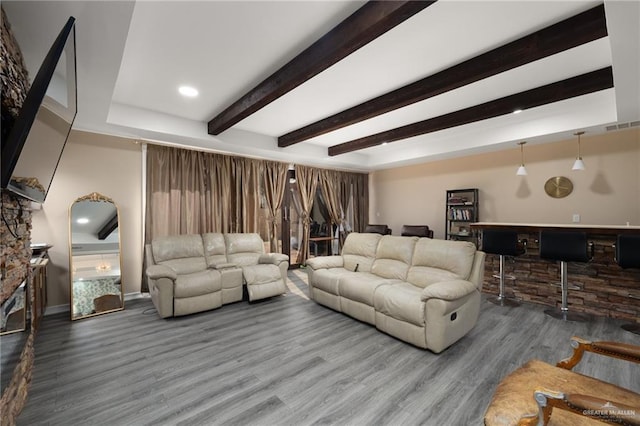 living room featuring bar, wood-type flooring, and beamed ceiling