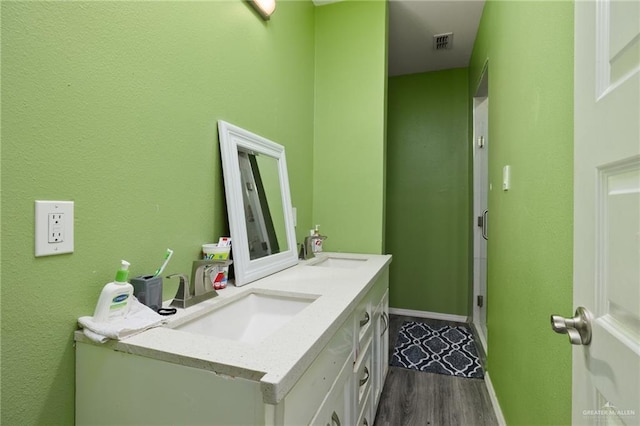 bathroom featuring vanity and wood-type flooring