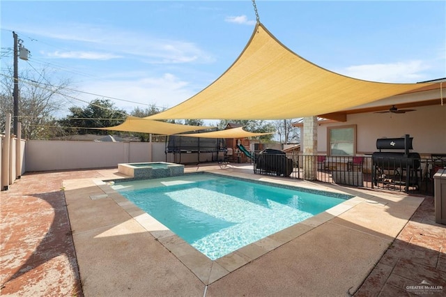 view of swimming pool with a playground, an in ground hot tub, area for grilling, and a patio area