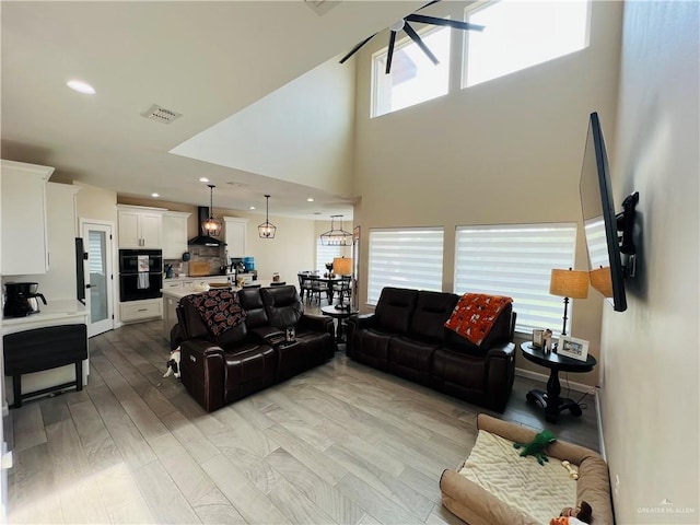 living room featuring a towering ceiling and a wealth of natural light