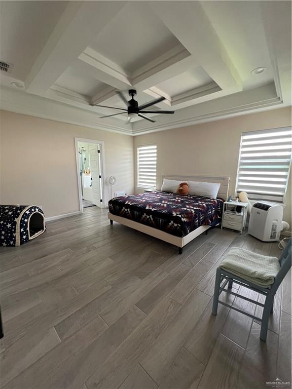 bedroom featuring coffered ceiling, hardwood / wood-style floors, ceiling fan, ornamental molding, and beam ceiling