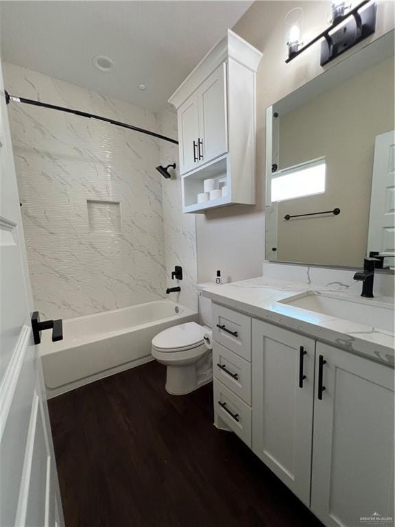 full bathroom with vanity, toilet, tiled shower / bath combo, and wood-type flooring