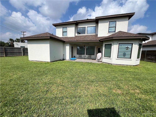 back of house with a patio area and a yard