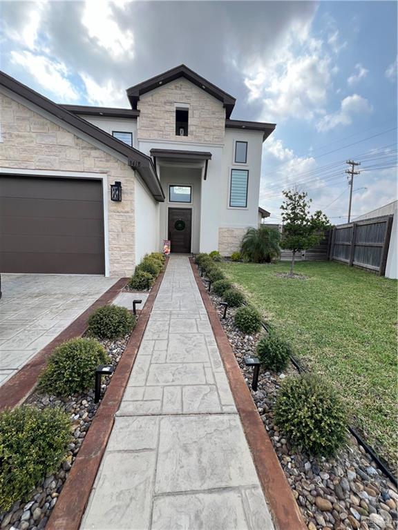 view of front of property featuring a front lawn and a garage