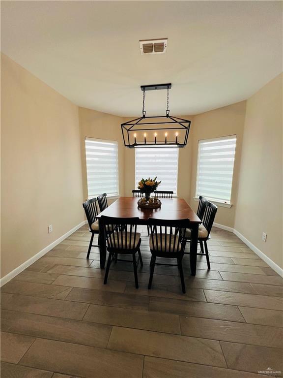 dining room with a healthy amount of sunlight and dark wood-type flooring