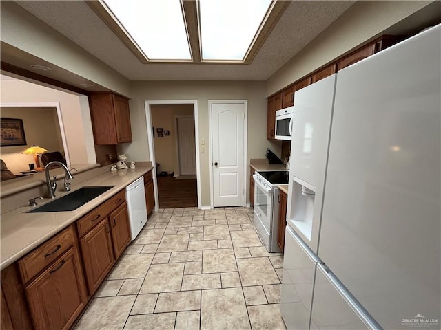 kitchen with white appliances and sink