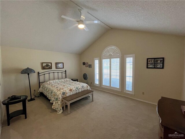 bedroom with ceiling fan, light colored carpet, lofted ceiling, and a textured ceiling