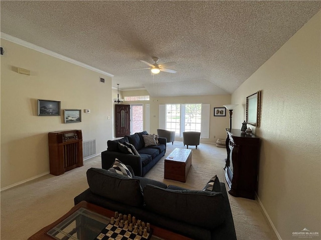 living room featuring light carpet, ornamental molding, a textured ceiling, ceiling fan, and lofted ceiling