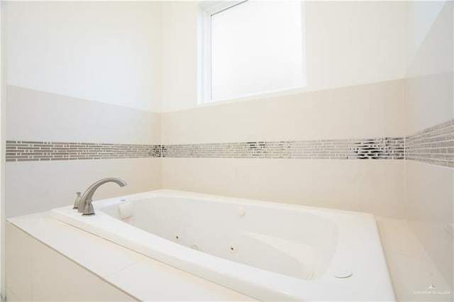 bathroom featuring tiled bath