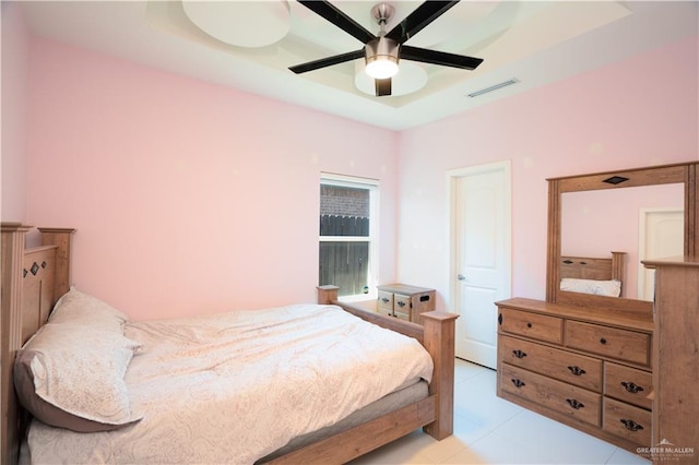 tiled bedroom featuring ceiling fan