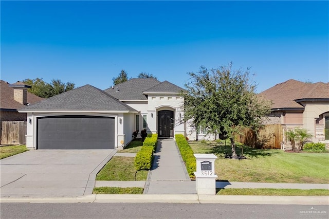 view of front of property with a garage and a front lawn