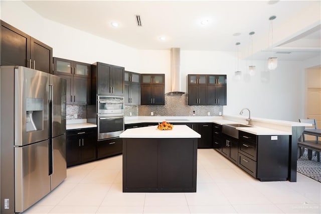 kitchen with a center island, sink, wall chimney range hood, and stainless steel appliances