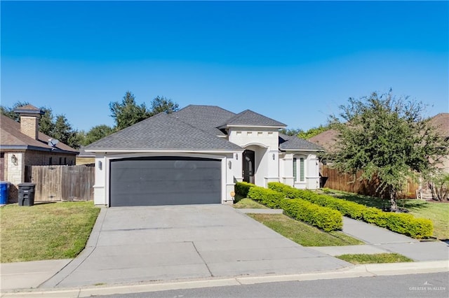 view of front facade featuring a garage and a front lawn