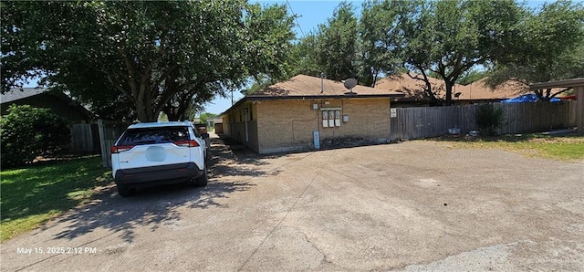 1009 W Champion St, Edinburg, TX 78539 - view of side of home featuring brick siding and fence