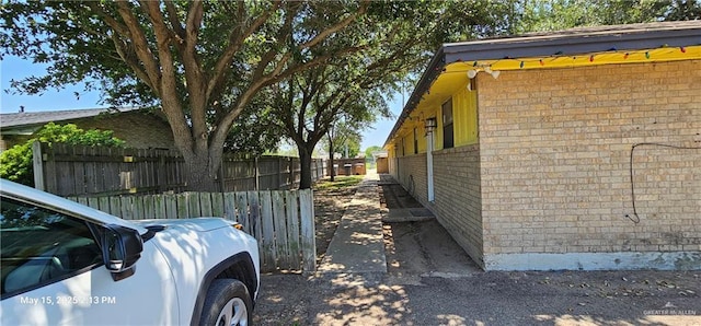 1009 W Champion St, Edinburg, TX 78539 - view of property exterior featuring brick siding and fence