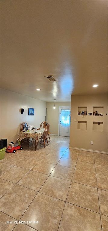 1009 W Champion St, Edinburg, TX 78539 - dining space with light tile patterned floors and recessed lighting