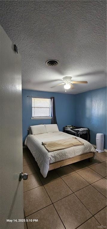 1009 W Champion St, Edinburg, TX 78539 - bedroom with tile patterned flooring, a textured ceiling, and ceiling fan