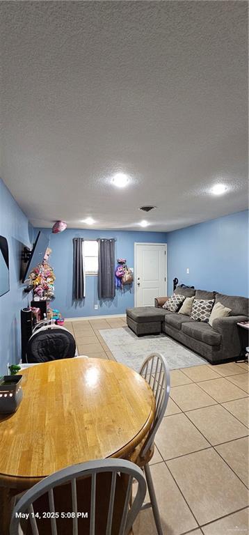 1009 W Champion St, Edinburg, TX 78539 - dining area with a textured ceiling and tile patterned floors