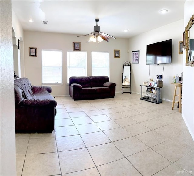 tiled living room with ceiling fan