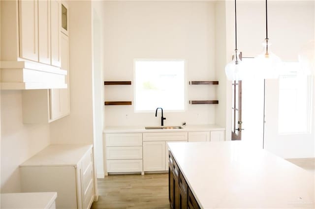 1904 Trophy Dr, Edinburg, TX 78542 - kitchen featuring open shelves, a sink, light wood-type flooring, and light countertops