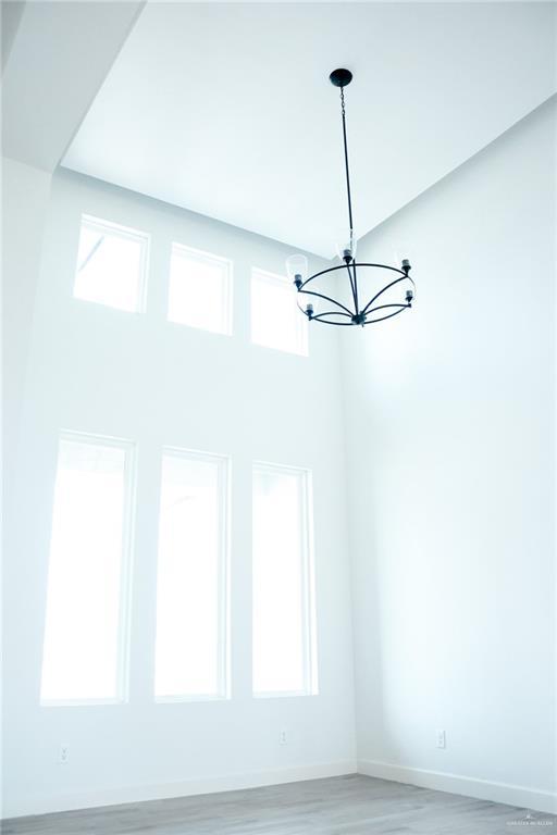 1904 Trophy Dr, Edinburg, TX 78542 - detailed view of a chandelier, baseboards, and wood finished floors