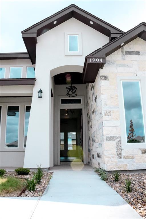 1904 Trophy Dr, Edinburg, TX 78542 - doorway to property featuring stone siding and stucco siding
