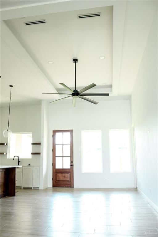 1904 Trophy Dr, Edinburg, TX 78542 - unfurnished living room with ceiling fan, baseboards, and light wood-style flooring