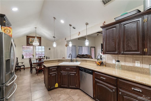 kitchen featuring stainless steel appliances, dark brown cabinets, and a sink