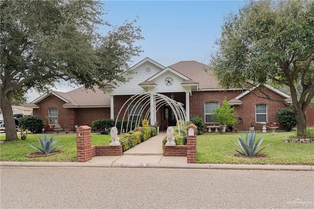 traditional-style house with brick siding and a front lawn