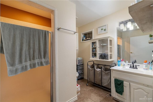 bathroom featuring a shower with shower door, tile patterned floors, and vanity