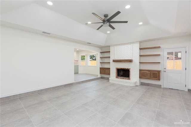 unfurnished living room featuring recessed lighting, visible vents, a raised ceiling, and a fireplace