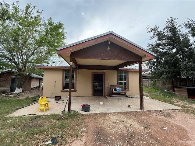 16805 Las Canas Dr, Edinburg, TX 78541 - back of house with a patio, stucco siding, and metal roof