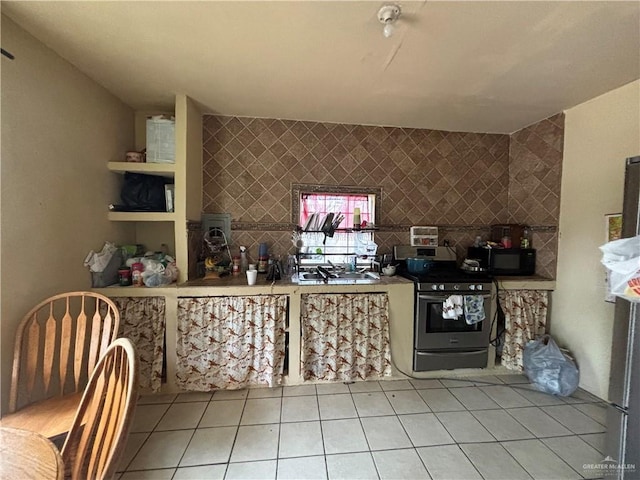 16805 Las Canas Dr, Edinburg, TX 78541 - kitchen with electric stove, black microwave, light tile patterned floors, and decorative backsplash