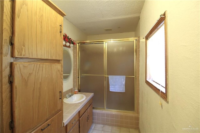11009 Monte Cristo Rd, Edcouch, TX 78538 - bathroom with vanity, a stall shower, and a textured ceiling