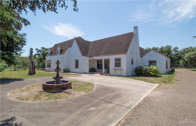 11009 Monte Cristo Rd, Edcouch, TX 78538 - view of front of house with curved driveway, a chimney, and stucco siding