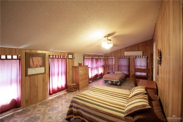 11009 Monte Cristo Rd, Edcouch, TX 78538 - bedroom featuring multiple windows, wood walls, lofted ceiling, a textured ceiling, and tile patterned floors